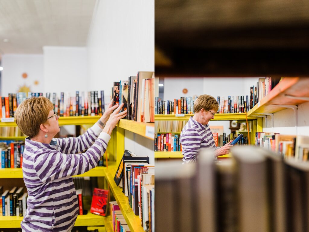 Customer looking at books in yellow shelves inside of Sundropo Books.