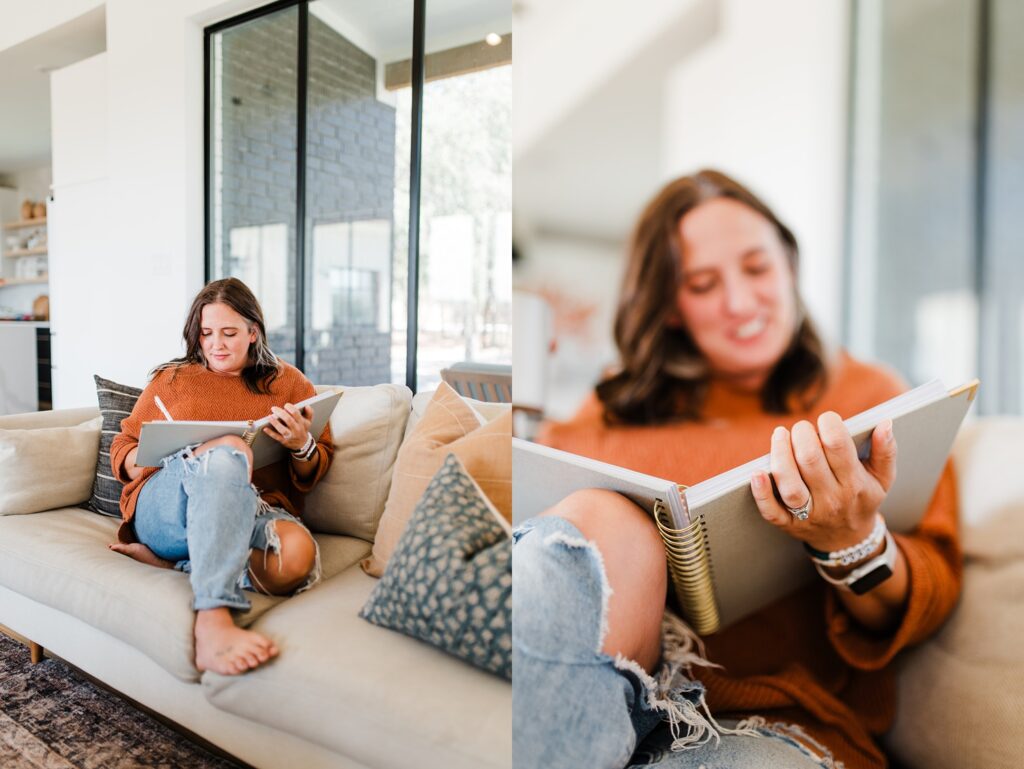 Woman sitting on couch writing in planner
