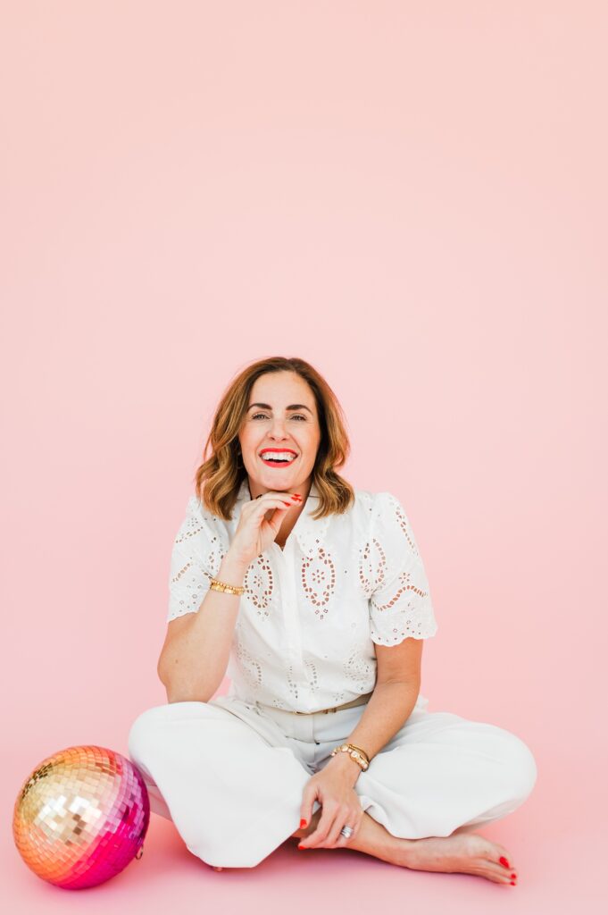 Brand photo of woman smiling against pink background