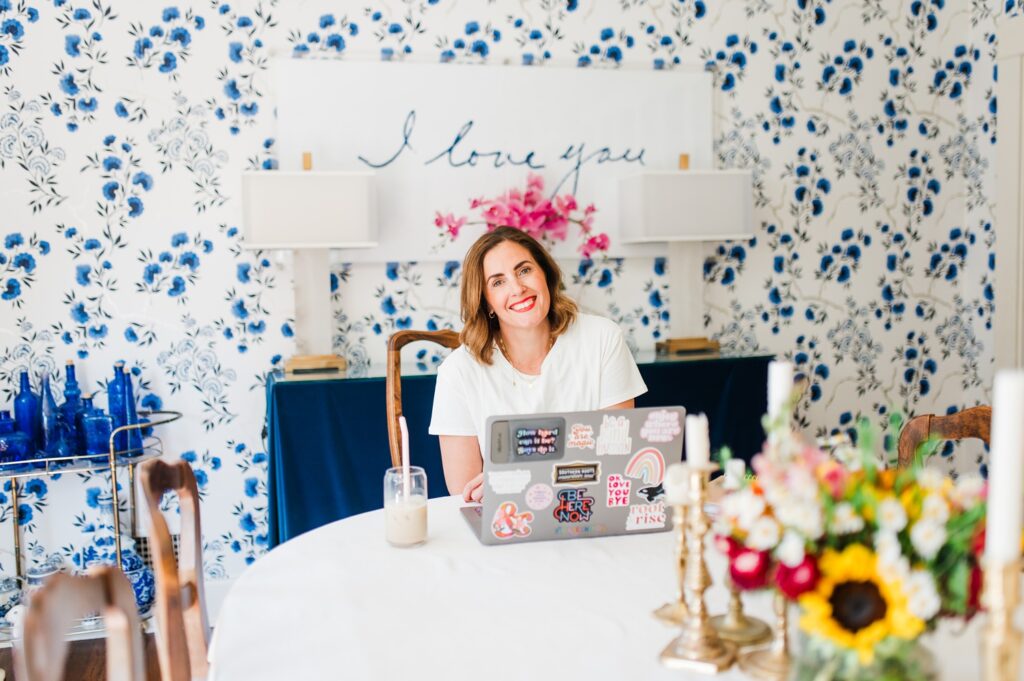Brand photo of woman sitting in her dining room working