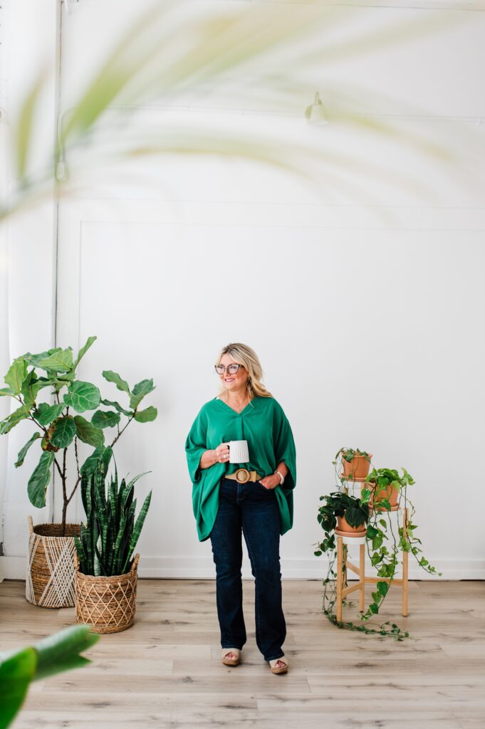 Brand photo of a North Texas Realtor Woman standing with plants and coffee