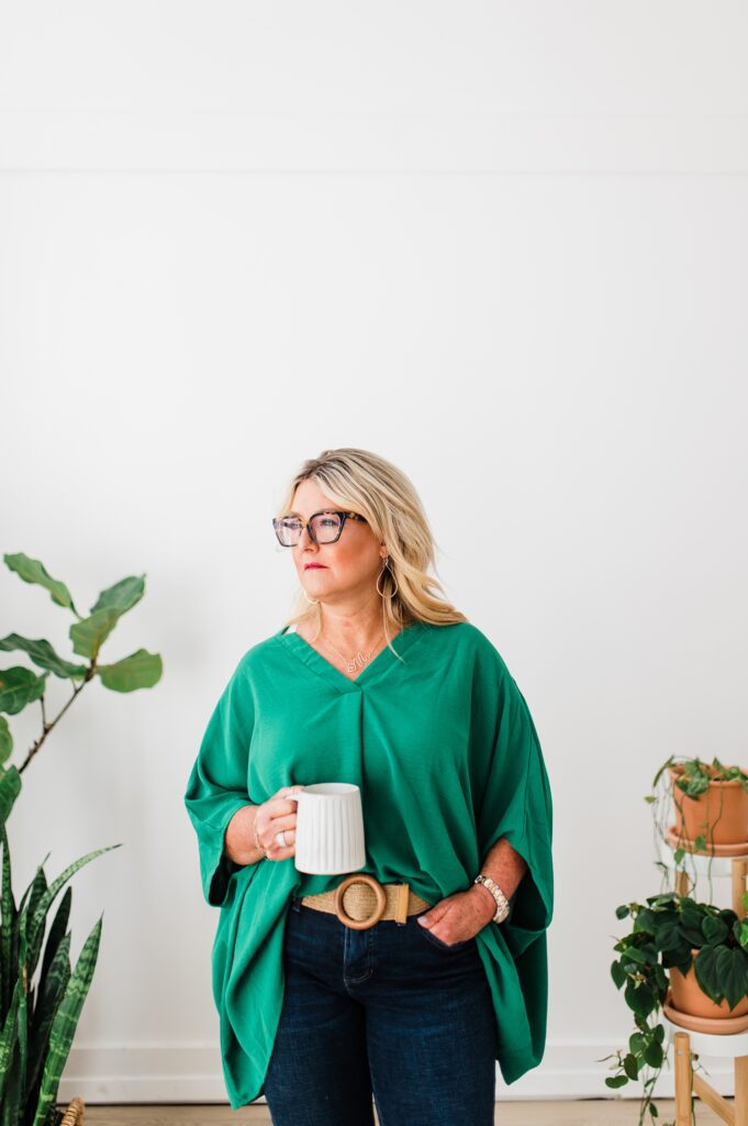 Brand photo of a North Texas Realtor Woman standing with plants and coffee