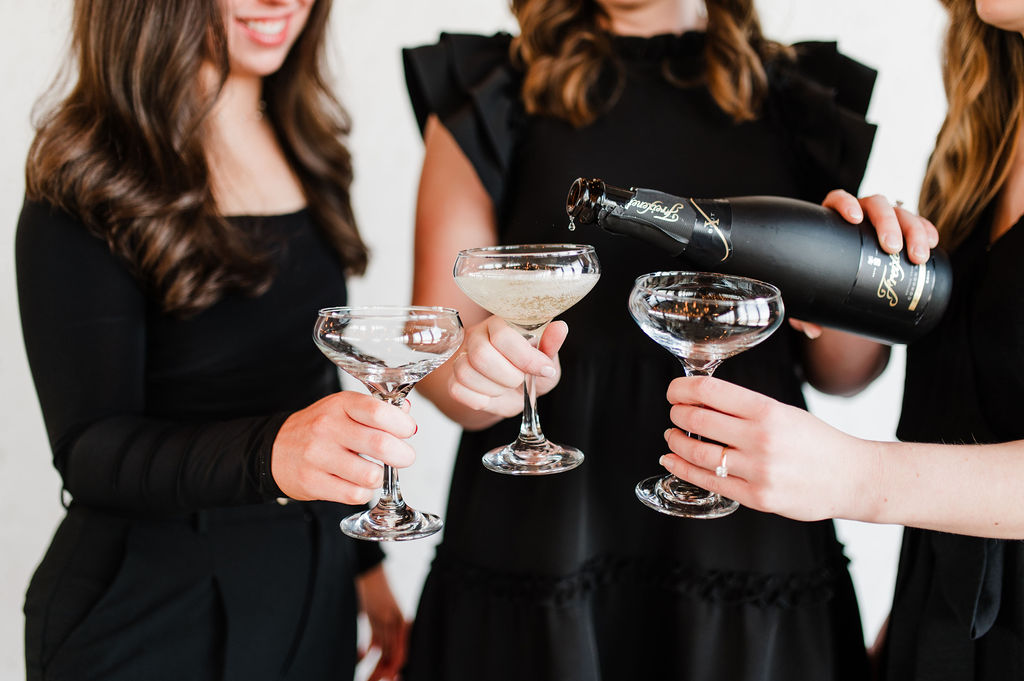 Brand photo of 3 wedding planners cheersing their champagne