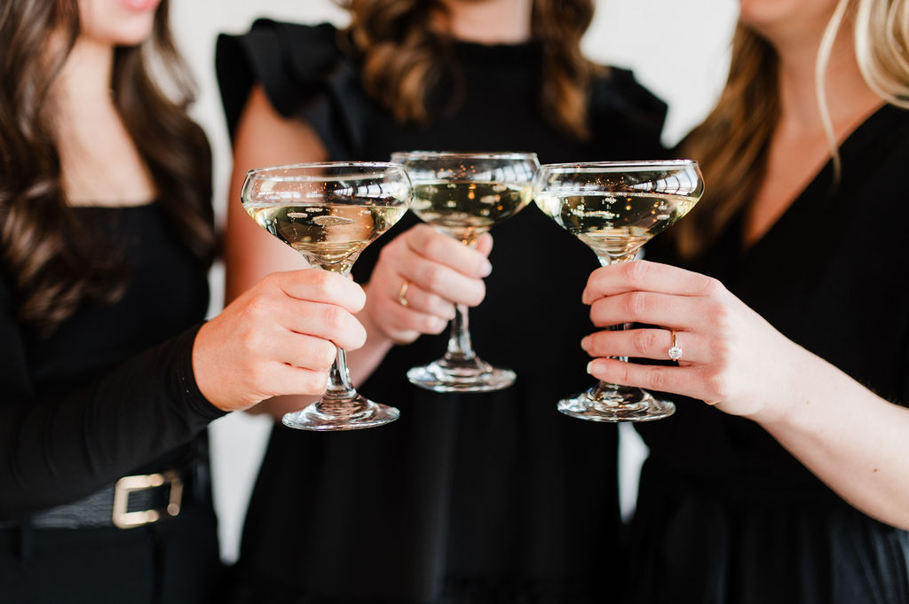 Brand photo of 3 wedding planners cheersing their champagne