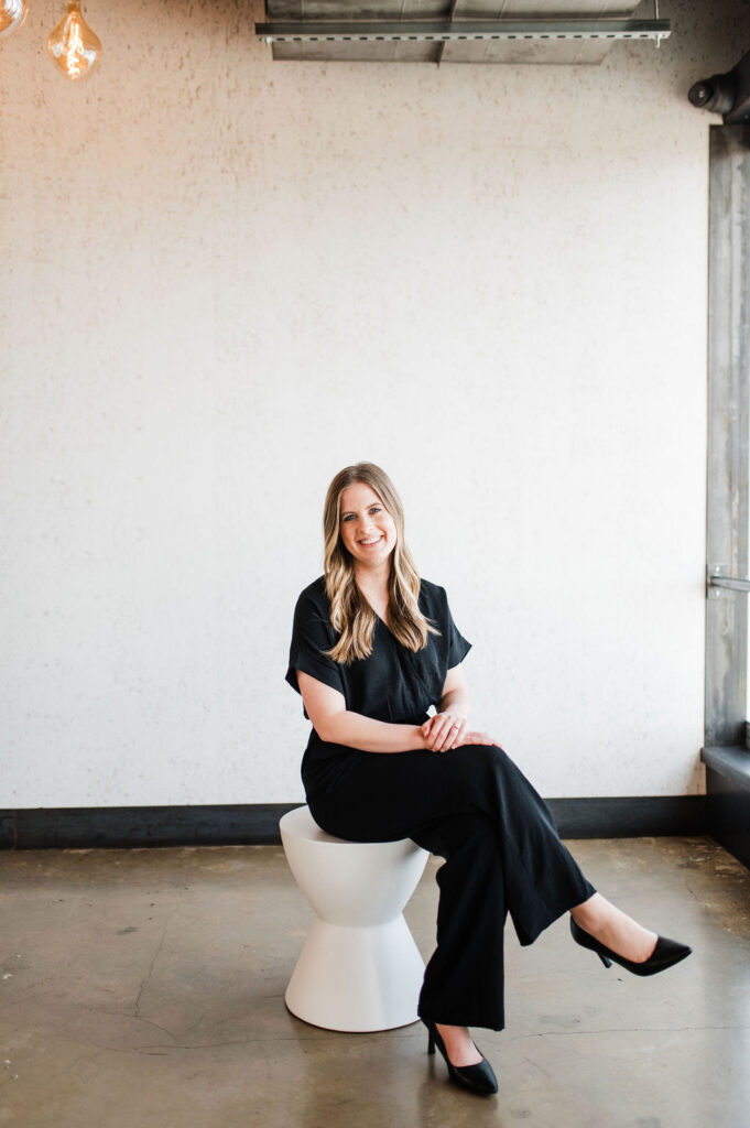 Brand photo of a wedding planner looking and smiling at the camera
