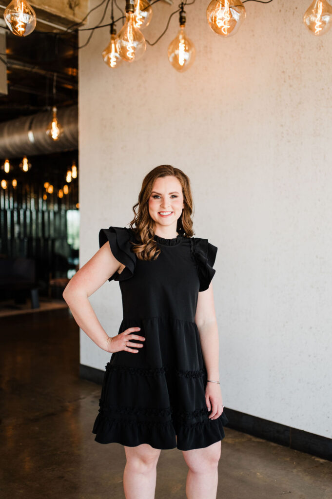 Brand photo of a wedding planner looking and smiling at the camera