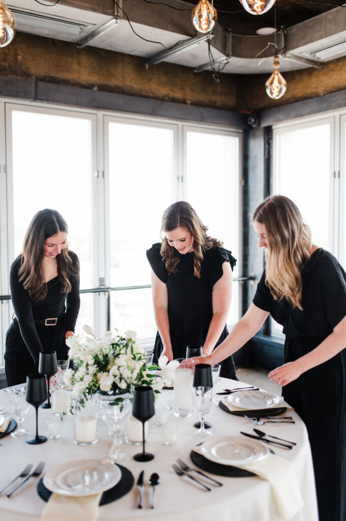 Brand photo of three wedding planners styling a table