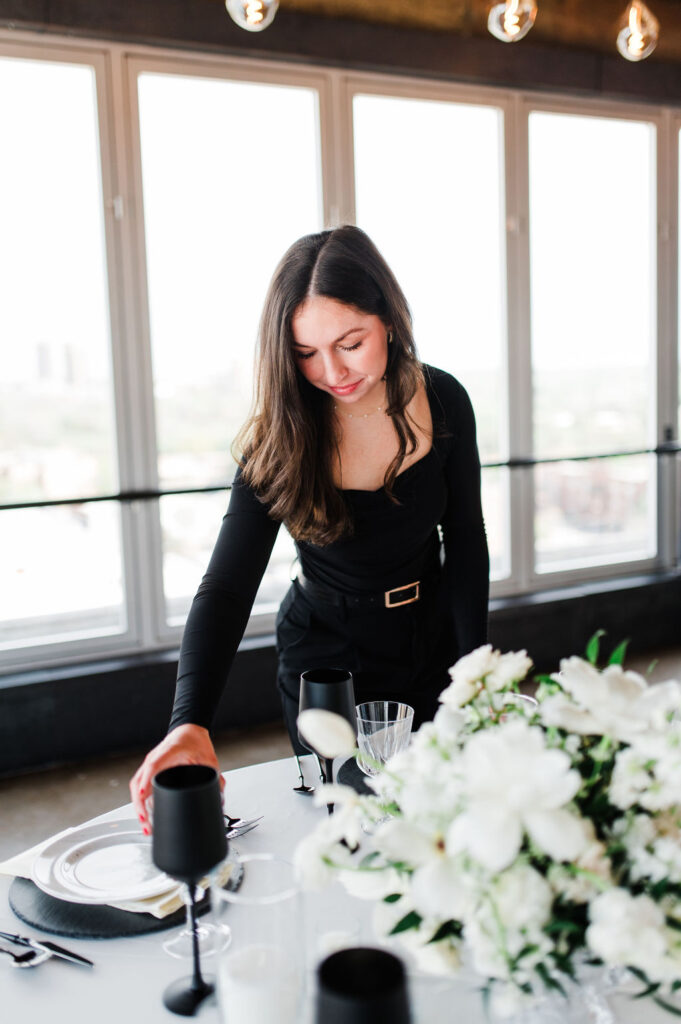 Brand photo of a wedding planner styling a table
