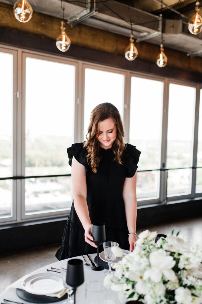 Brand photo of a wedding planner styling a table