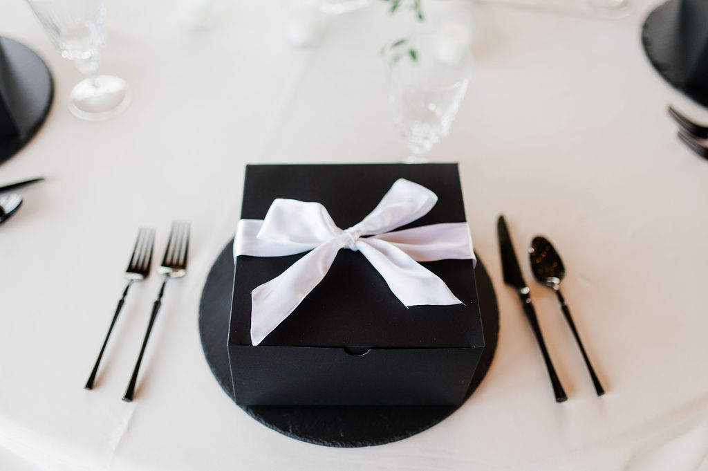 Brand photo of a black box sitting on a beautifully designed table setting