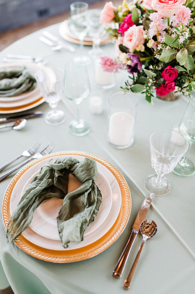 Brand photo of a green and white table setting put together by a wedding planner
