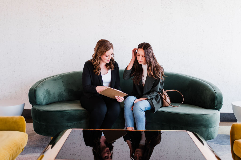 brand photo of a wedding planner walking through a venue with a potential client