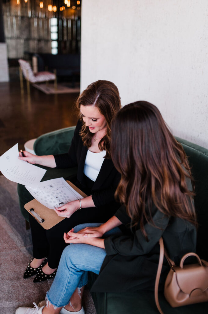 brand photo of a wedding planner walking through a venue with a potential client