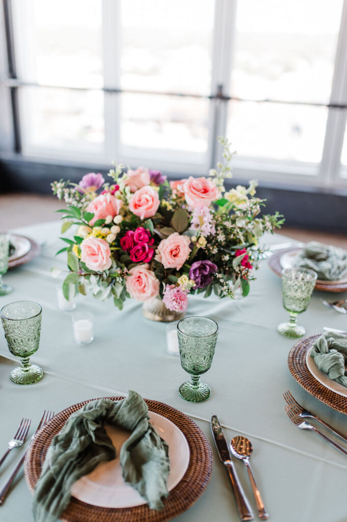 Brand photo of a green and white table setting put together by a wedding planner
