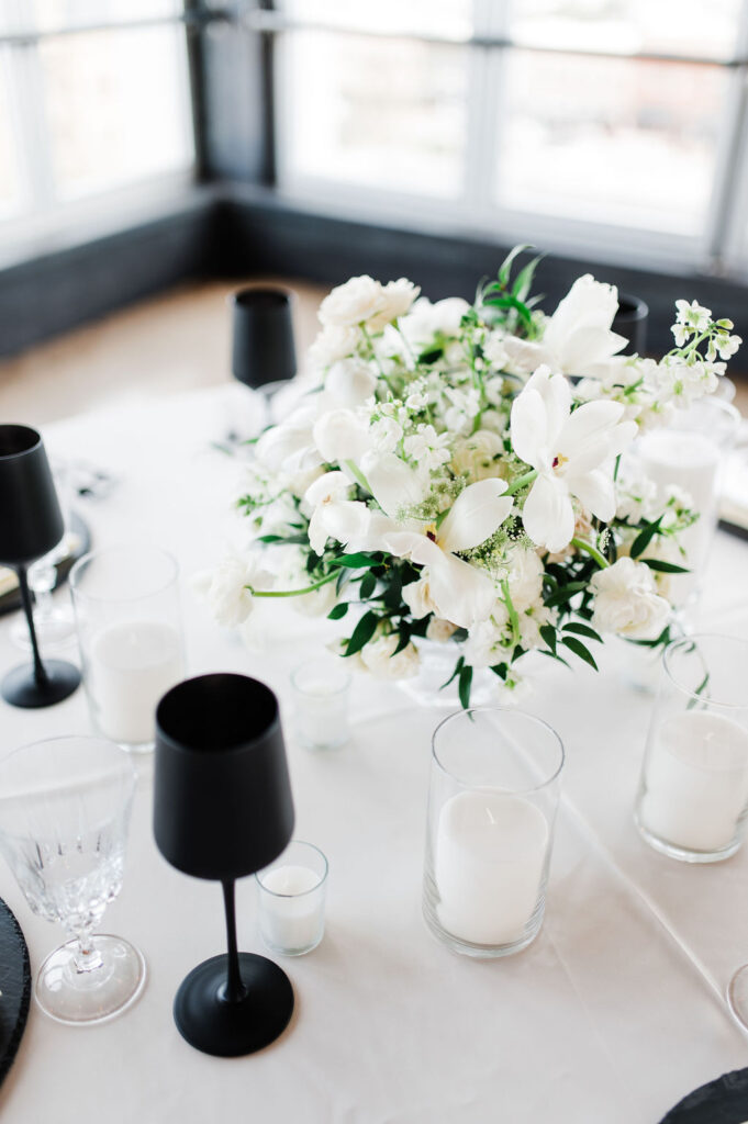 black and white florals on a table setting setup by a wedding planner