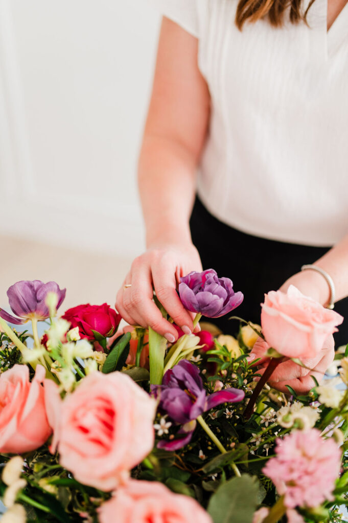 brand photo of a wedding planner adjusting florals