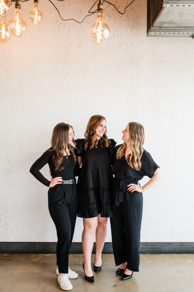brand photo of 3 wedding planners standing together laughing